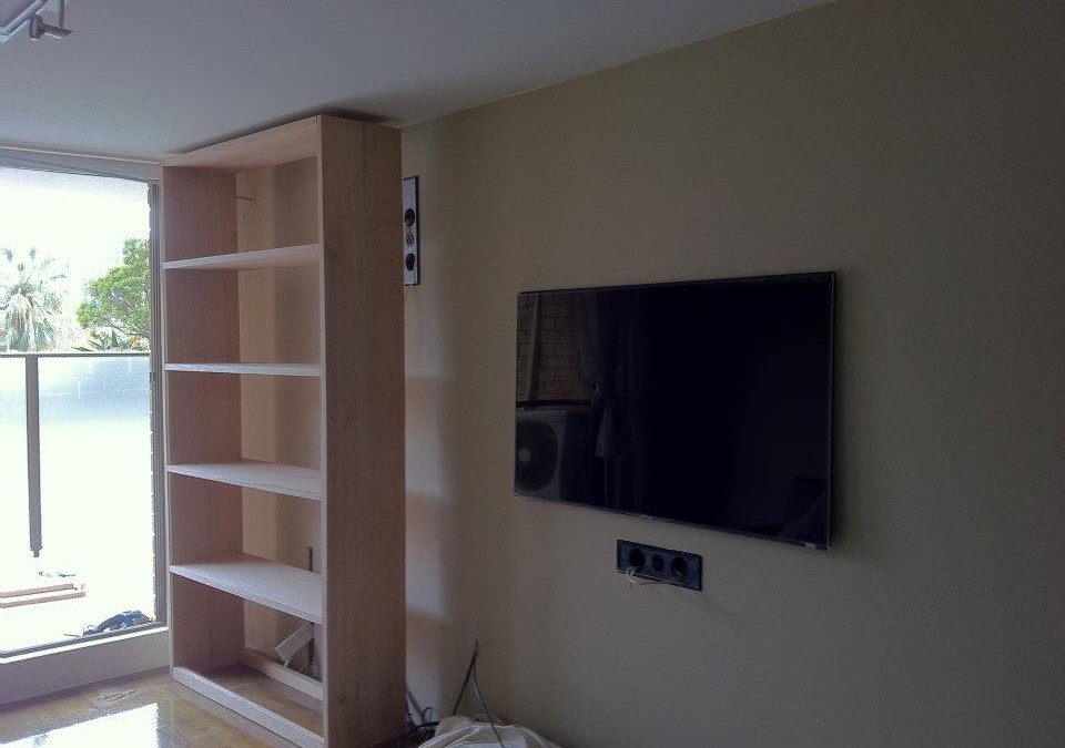 Custom built-in TV and hardwood bookcase